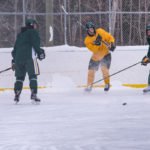 Shooting the puke down the ice toward the green side.