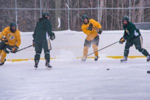 Shooting the puke down the ice toward the green side.