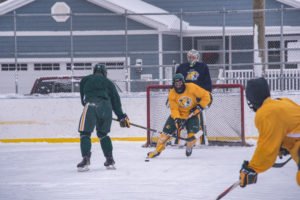 The yellow team in possession of the puck.