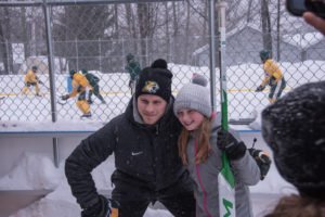 Kids brought hockey sticks and NMU apparel to have signed by players.