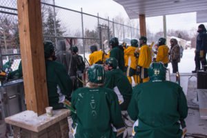 Hockey players waiting to get on the ice.