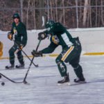 Both teams trying to claim control of the puck.