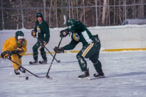 Both teams trying to claim control of the puck.
