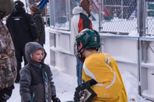 This little boy was telling NMU hockey player #3 all about this plans to be on the team one day.