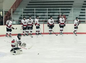 The Redmen warm up ahead of their bout against Gross Pointe South.