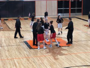 Opponents stand over the Escanaba 'E' as they shake hands before the game.