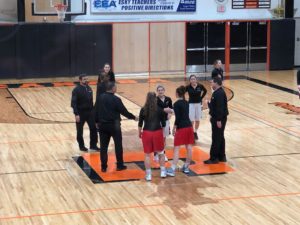 Opponents shake hands before tip off.