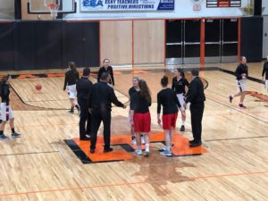 The Redettes and the Eskymos greet each other before the game.