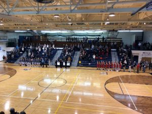 Players stand for national anthem.