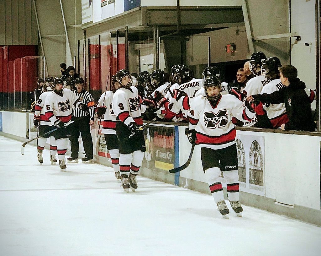 Redmen teammates congratulate each other for a goal.