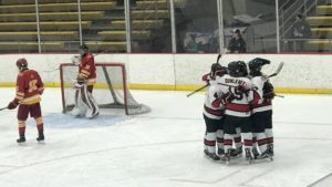 The Redmen celebrate after a goal during their battle with the Hancock Bulldogs Wednesday night