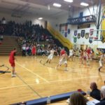 The Marquette Redmen work a play against the Negaunee Miners Thursday night
