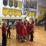 The Marquette Redmen and their coaches celebrate their win