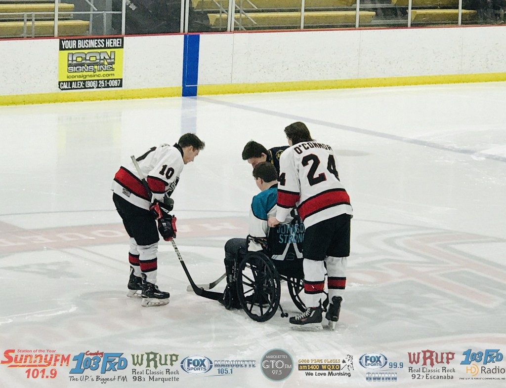 The Marquette Redmen honor the victims of a tragic accident earlier in the year