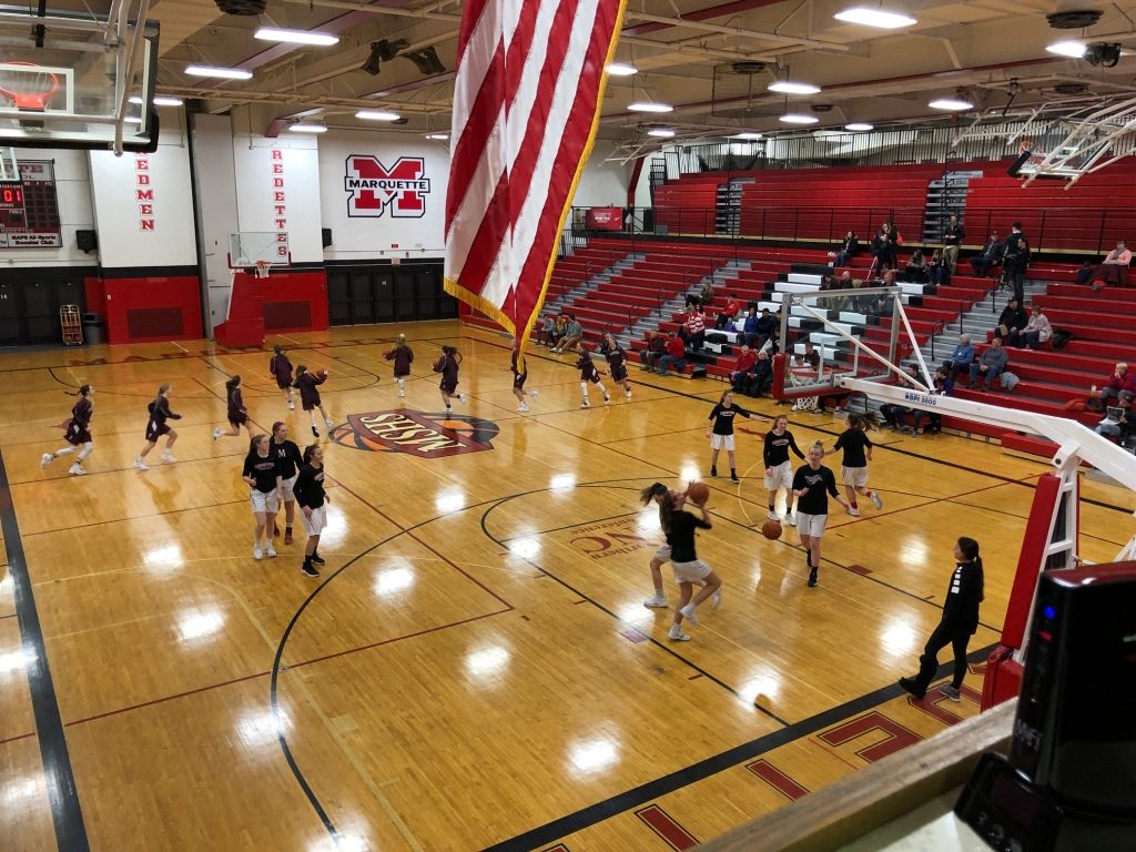 The Marquette Redettes and Menominee Maroons battle it out on the court.