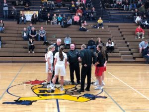 Opponents shake hands ahead of the game.