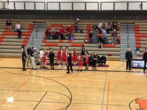 The Redettes line up at their bench.