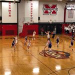 The Redettes drive down the court.