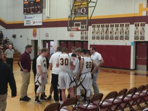 The Maroons huddle up.