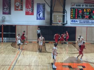 The Redmen charge down the court.