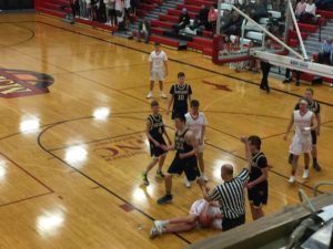 A Redmen connected with the floor going for the ball.