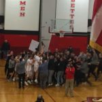 Fans, players, parents, and coaches all celebrate together