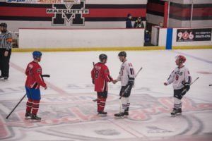 The teams met on the ice to congratulate each other on a game well played.