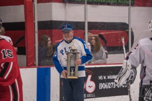 The Pigs coach with the Pigs-N-Heat Trophy