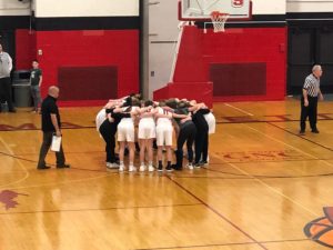 The Redettes huddle up before their match-up against the TC West Titans.