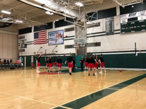 The Redettes warm up ahead of their district quarterfinal match-up against the Alpena Wildcats.