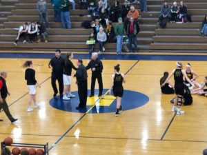 Opponents take center court before tip off.