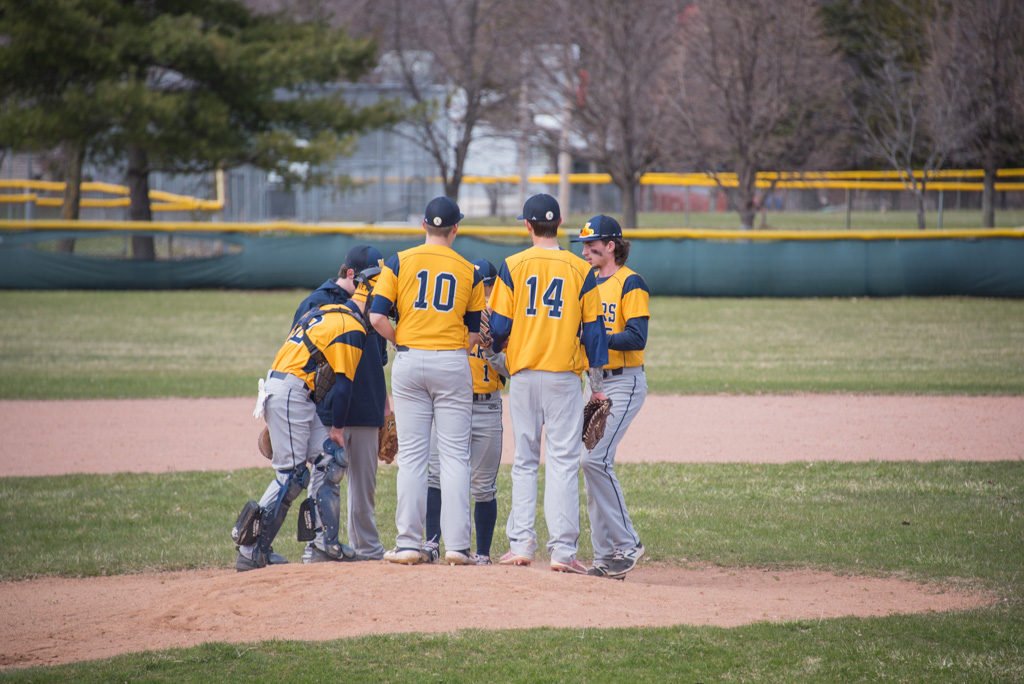 The Negaunee Miners take a break at the mound to focus their defense