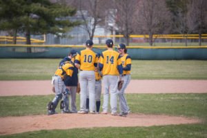 The Negaunee Miners take a break at the mound to focus their defense