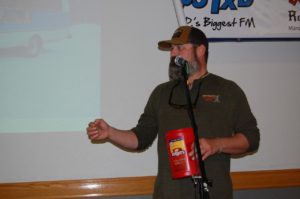 Adam reading off door prize ticket numbers.