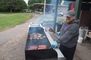 Grillin up some burgers and brats at the Grab-n-Go station.