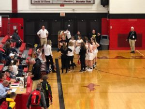 The Redettes during a timeout getting instructions from head coach Ben Smith