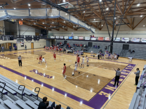 Marquette Redmen boys basketball team taking on the Gladstone Braves