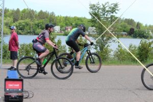 Lake Bancroft in the background as bikers go by