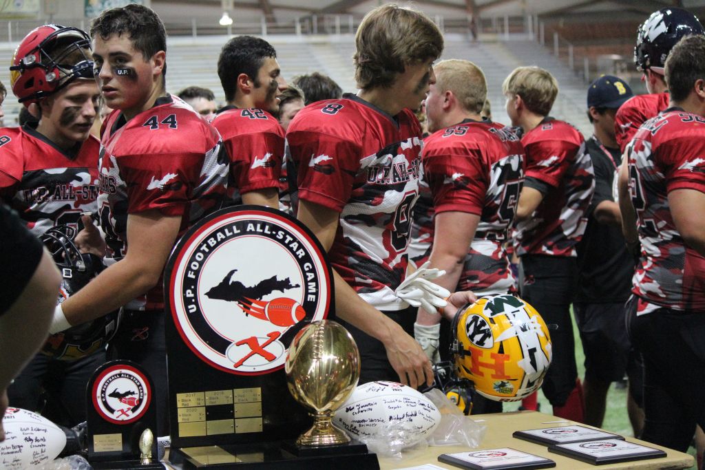 Red Team gathered around for signing the commemorative football