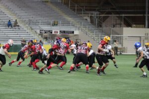 Red team passes the ball behind while Black scrambles
