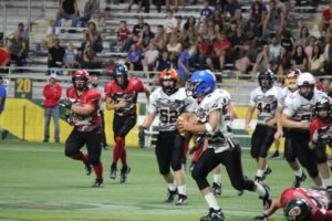 Black team dashing toward the touchdown zone