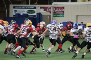 Black closes in on Red, running with the ball