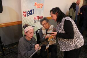 Abbie is grabbing the winner's names