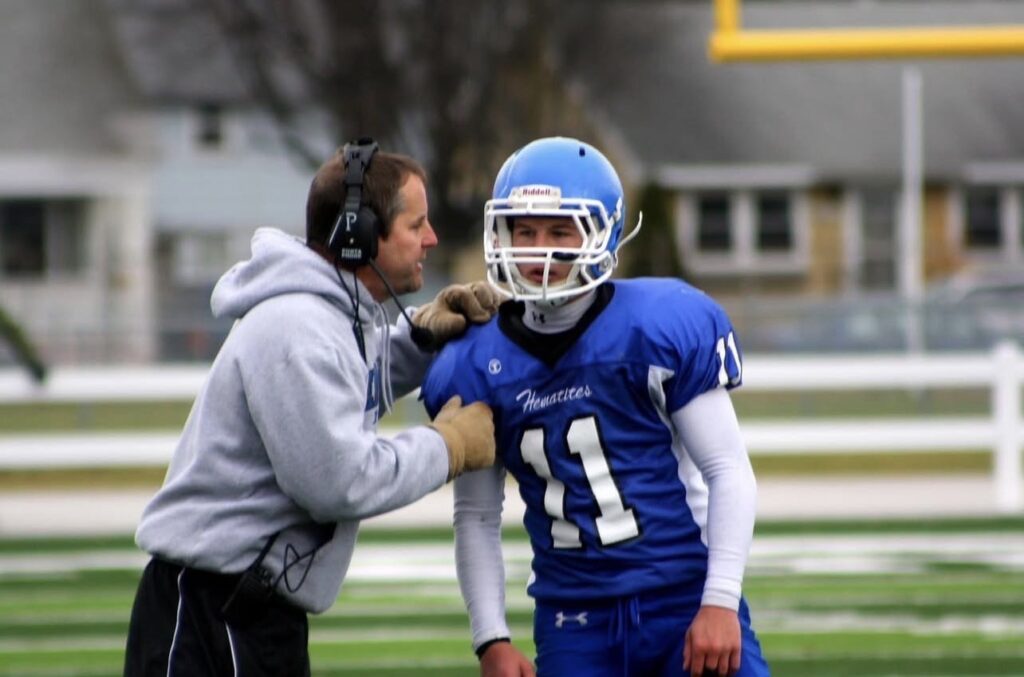 Coach Olson gives the play to his son Daniel