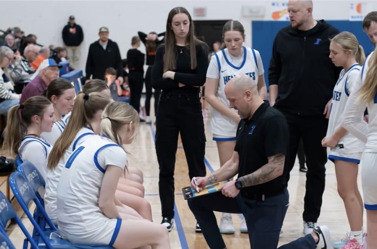 Makaylee Kuhn watches coach Reichel draw up play